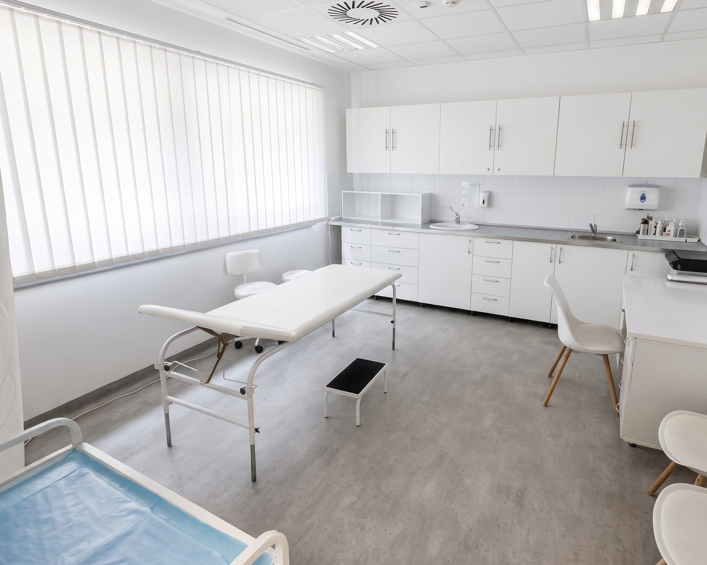 A consulting room with an examination couch beside the window